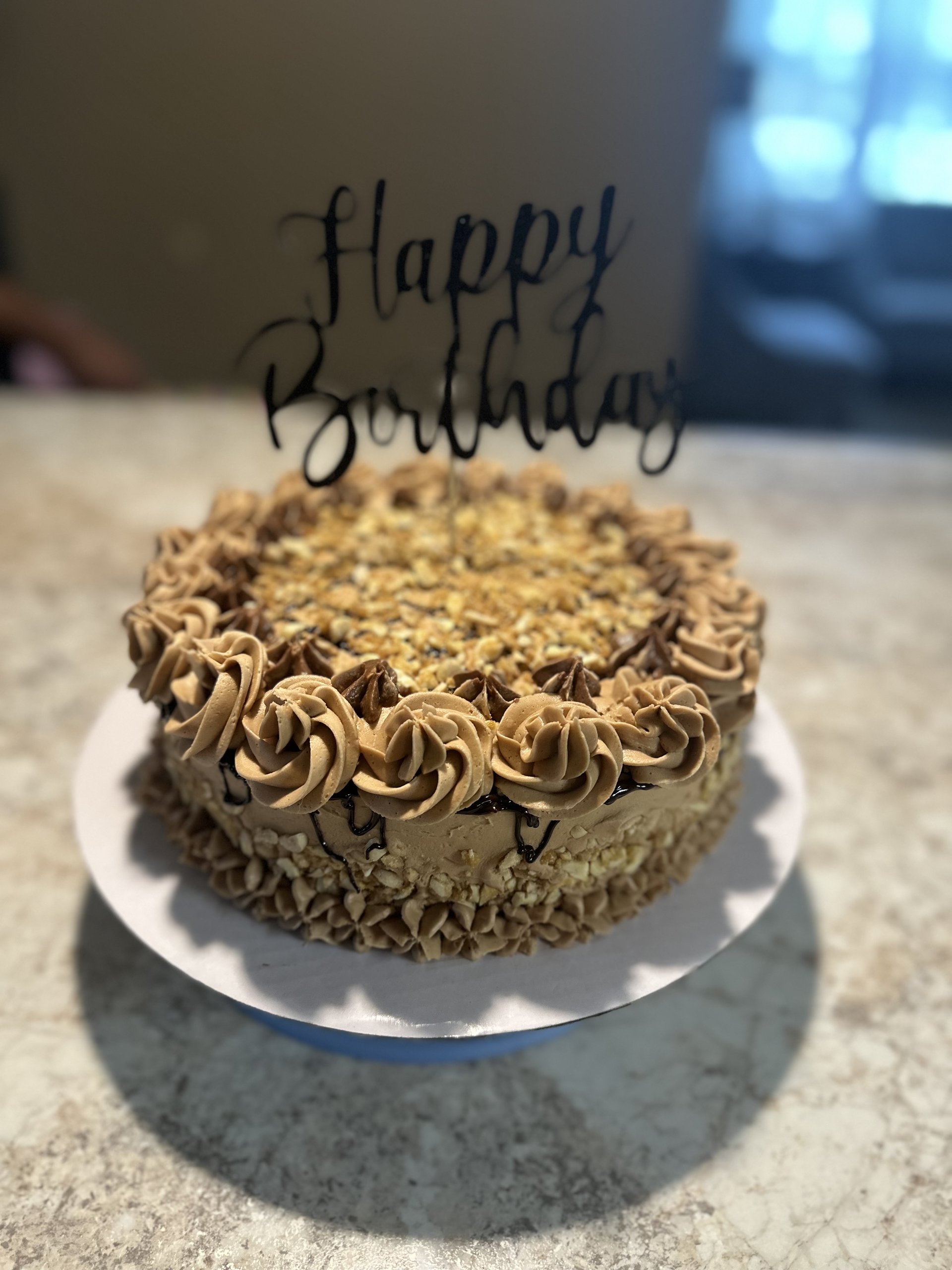 Celebration cake with golden buttercream rosettes