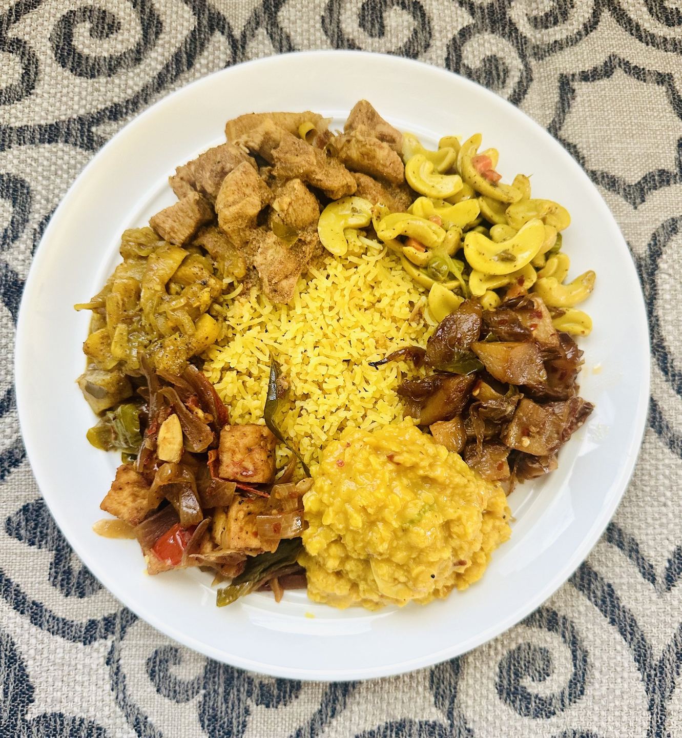 Yellow rice with chicken curry and vegetables